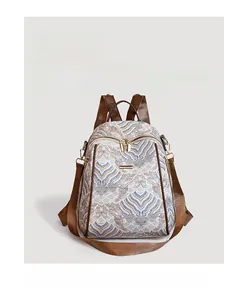 Detail of beige backpack featuring retro blue wave patterns and dark brown shoulder straps