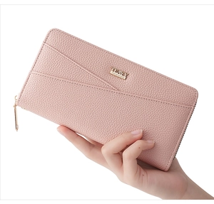 Detail of pink long leather purse with lychee pattern and gold zipper for women