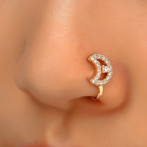 Close-up of a non-pierced gold moon-shaped nose ring with sparkling zircon stones