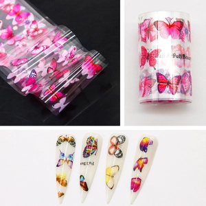 Macro shot of pink butterfly nail transfer foil and finished application on nails