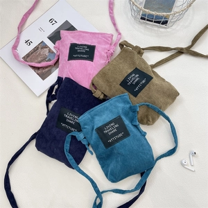 Detail view of corduroy crossbody phone bags in pink, navy, khaki and teal colors