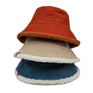 Double-sided lamb wool bucket hats for women in orange, beige, and navy blue