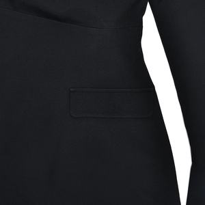 Detailed macro view of the sleek waist pocket and premium fabric on a black blazer