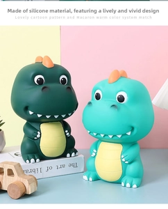 Detail view of cartoon dinosaur piggy banks in dark and light green soft vinyl material