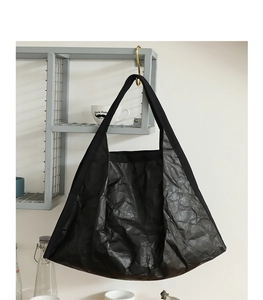 Detail showing the black wrinkled texture of the large capacity paper style tote bag