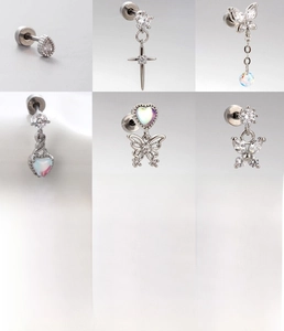 Detail of silver titanium steel screw back earrings set with zircon heart and butterfly