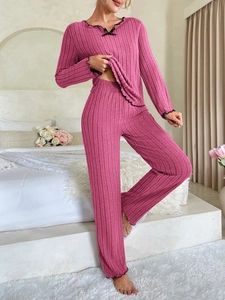 Close-up of ribbed texture loungewear with black ruffled edges and a small bow detail