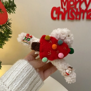 Close-up of red and white plush Christmas elk hair claw with festive decorations