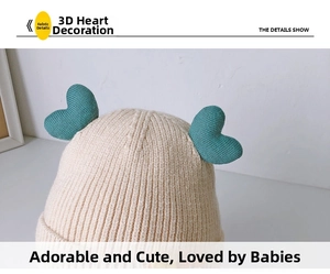 Close-up of baby knitted beanie featuring cute blue heart decorations and fine rib texture