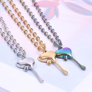 Detail view of heart-shaped liquid-drop pendants in silver, gold, and iridescent finishes