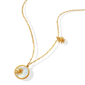 Golden paperclip chain necklace with round mother-of-pearl pendant and daisy flower detail