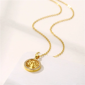 Gold Tree of Life circular pendant necklace with sparkling cubic zirconia on white background