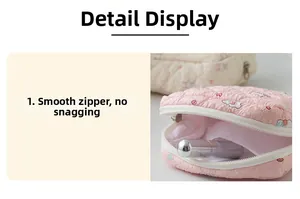Pink quilted portable sanitary bag showing internal capacity for lipstick and pads