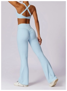 Rear view of light blue yoga set featuring cross-back sports bra and flare leggings
