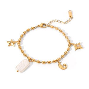Detail of gold bracelet with rectangle pearl charm and moon star pendants on white background