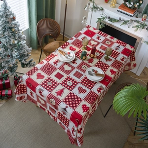 Rectangular Christmas tablecloth featuring red plaid patchwork and festive holiday patterns