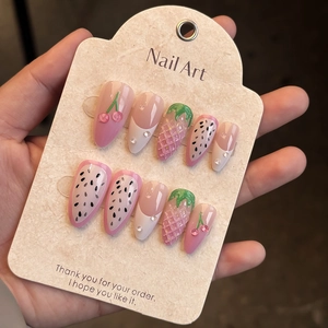 Macro shot of 3D strawberry and cherry relief on almond press-on nails set