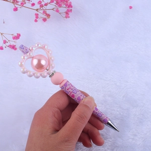 Pink heart silicone bead pen with pearl and rhinestones featuring LOVE pattern design