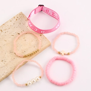 Detailed set of five pink beaded bracelets with pearls and WWJD printed ribbon on stone