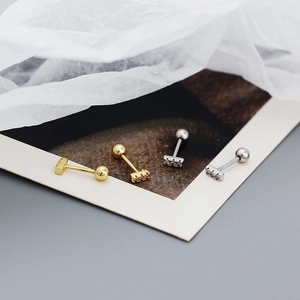 Macro shot of silver and gold plated 925 sterling silver bar earrings with zircon stones