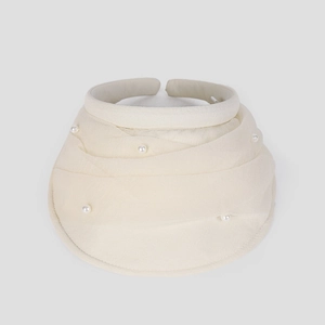 Detail of cream sun visor with layered ruffles and elegant faux pearl embellishments