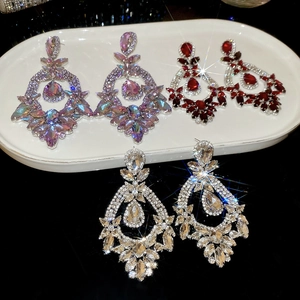 Close-up of sparkling oval teardrop earrings in purple, red and white crystal sets