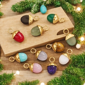 Handcrafted acorn pendants with colorful natural stones and gold metal caps on pine branches