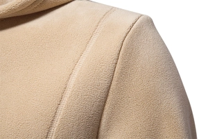 Macro shot of beige polar fleece hoodie shoulder seam and soft fabric texture