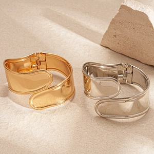 Minimalist wide metal irregular cross open bangle in polished gold and silver finish