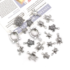 Detailed view of antique silver sea turtle charms with intricate shell patterns for DIY jewelry