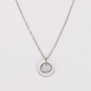 Detail view of silver stainless steel necklace with circle and heart pendant