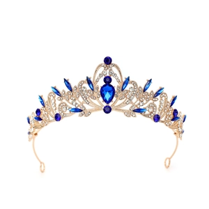 Macro detail of luxury gold bridal crown featuring teardrop blue crystals and white rhinestones
