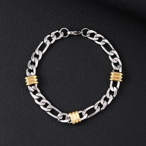 Detailed close-up of a two-tone silver and gold stainless steel Figaro chain bracelet