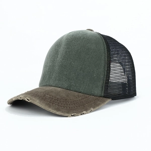 Distressed green and brown mesh trucker hat with vintage washed finish and curved brim