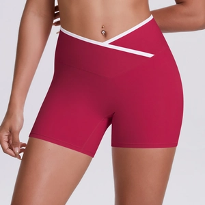 Detail of high-waist yoga shorts featuring a contrast white V-shape crossover waistband