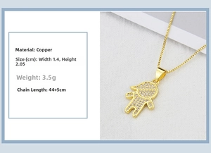 Detail of 18k gold plated boy girl pendant with cubic zirconia stones on copper base