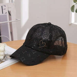 Women black mesh baseball cap with sequin patterns and heart detail on a wooden table