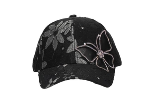 Detail of floral lace baseball cap featuring a 3D butterfly with colorful rhinestones