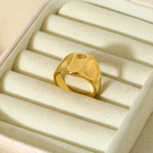 Waterproof hammered 316L stainless steel wide ring in 16K gold finish on a beige box