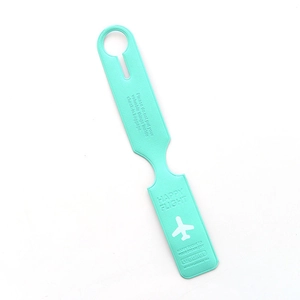 Detail of turquoise faux leather luggage tag with embossed flight safety instructions