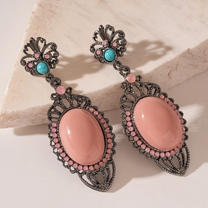 Vintage bohemian floral earrings with pink oval stones and turquoise beads on marble stone