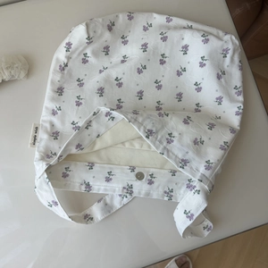 Close-up of small floral patterns, cotton fabric texture, and magnetic metal snap closure