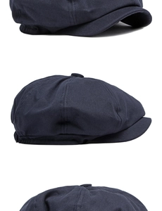 Detailed side views of dark blue cotton twill newsboy cap with eight-panel crown design
