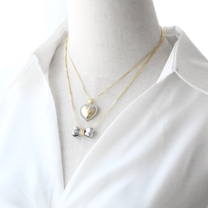 Gold layered heart pendant necklace and two-tone bow knot with cubic zirconia details
