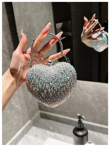 Detailed close-up of heart-shaped acrylic evening bag with colorful sparkling rhinestones