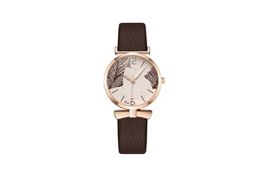 Detailed macro view of the rose gold watch case and leaf print dial with leather strap