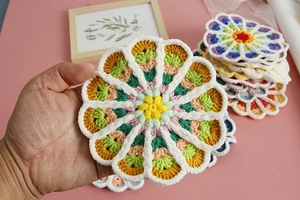 Macro shot of hand-crocheted mandala flower coaster with colorful gradient yarn details