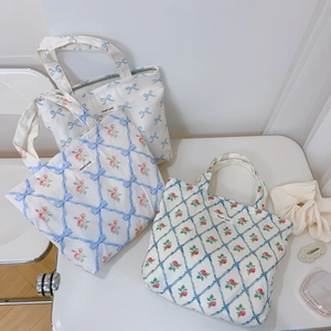 Three variants of floral canvas tote bags with blue ribbon prints and simple wish tags