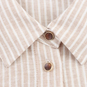 Close-up of striped cotton linen shirt collar with gold thread and metallic buttons