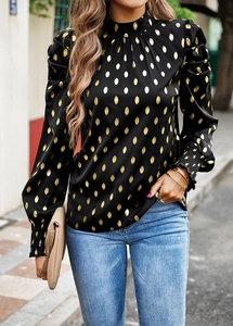 Detail of high collar and gold polka dots on elegant black long sleeve blouse